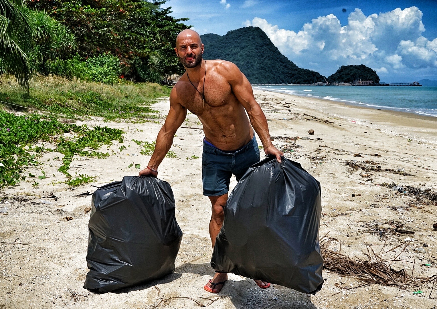 Giacomo Abrusci with trash bags after a beach cleanup